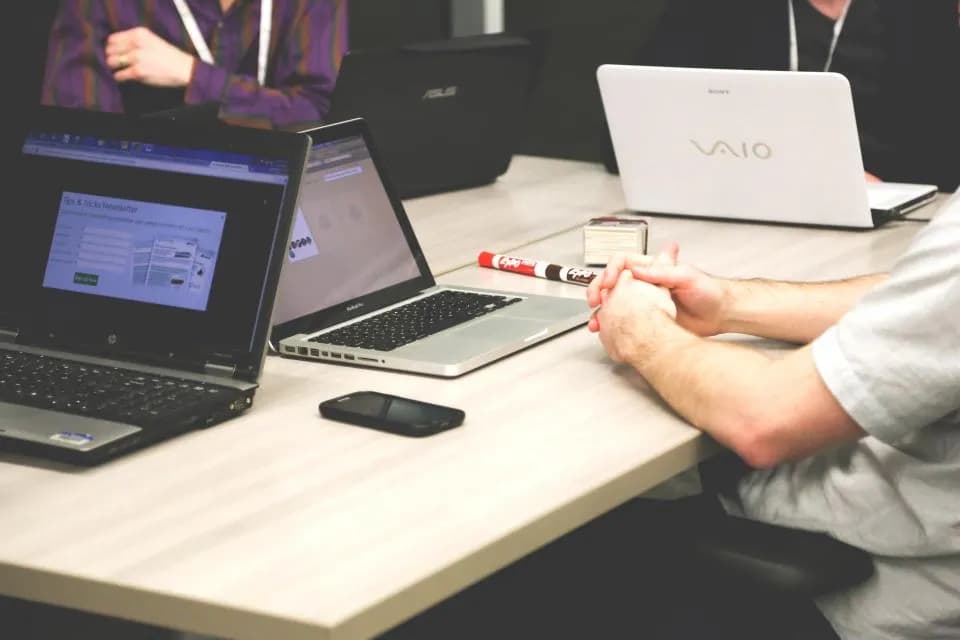 Laptops on a shared desk in an office